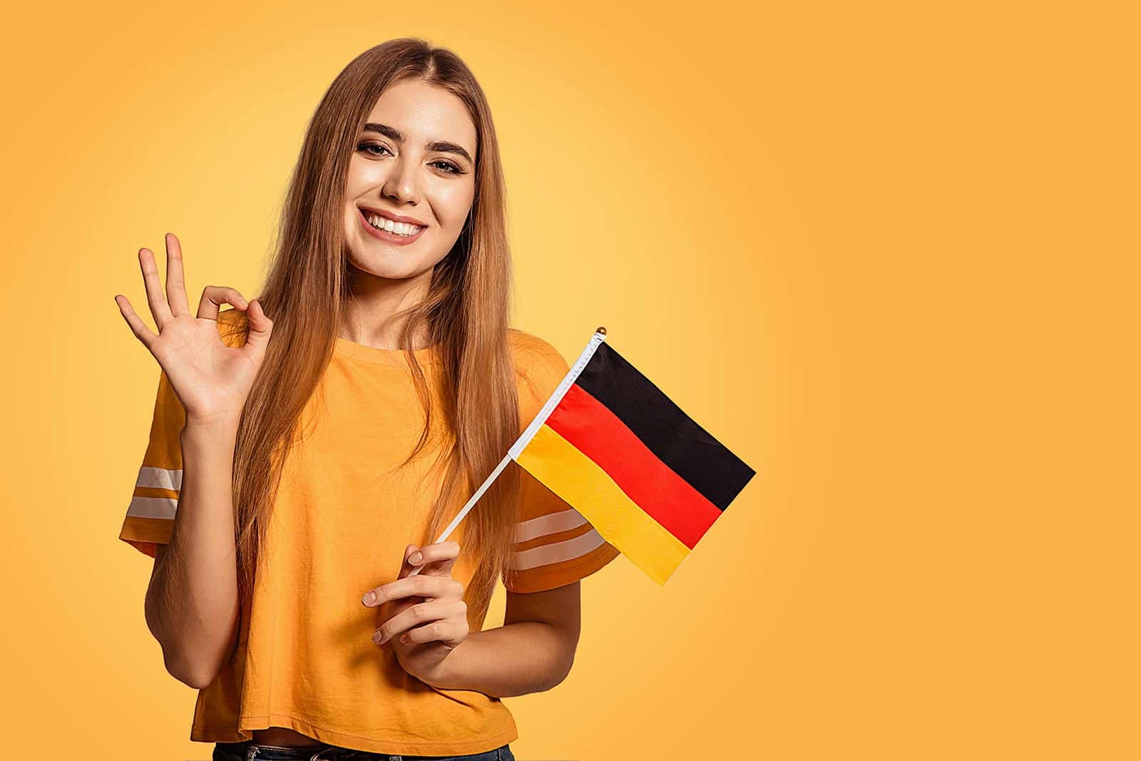 Сделать по немецкому по фото. Девушка с германским флагом. Немецкий флаг. Немецкий язык девушка. Девочка учит немецкий.